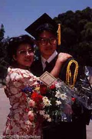 A graduate with his sister; Actual size=180 pixels wide